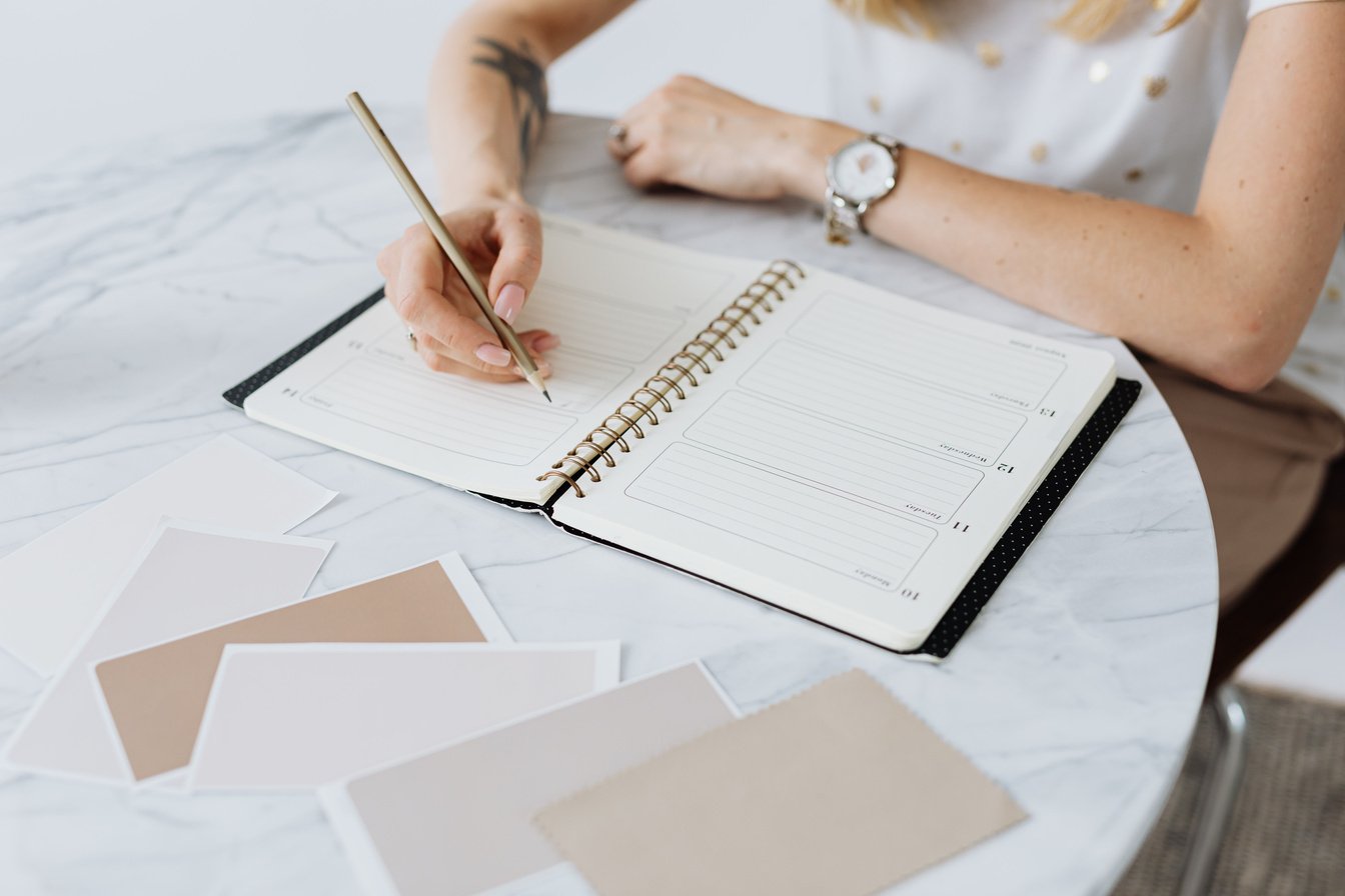 Person Writing on a Planner